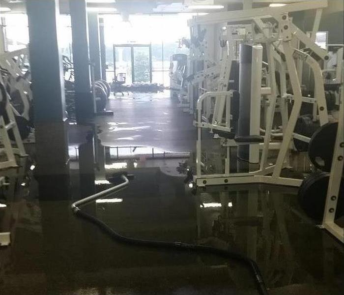 flooding water on floor with gym equipment