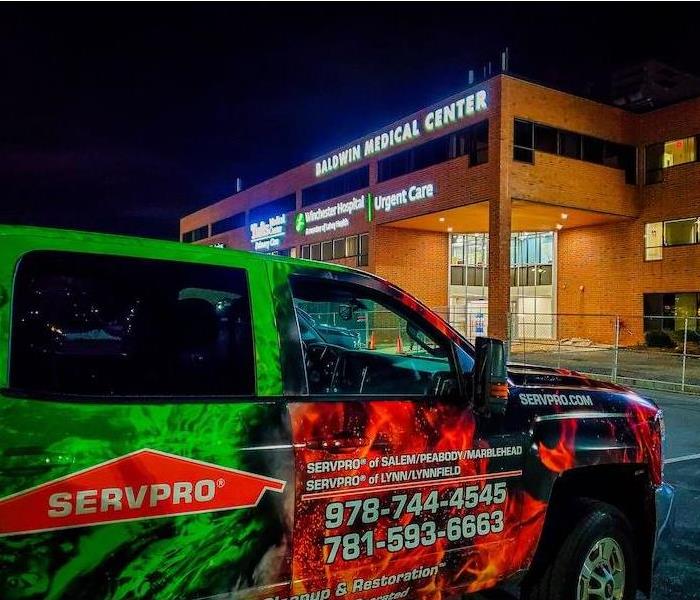 SERVPRO service vehicle in front of a medical facility at night