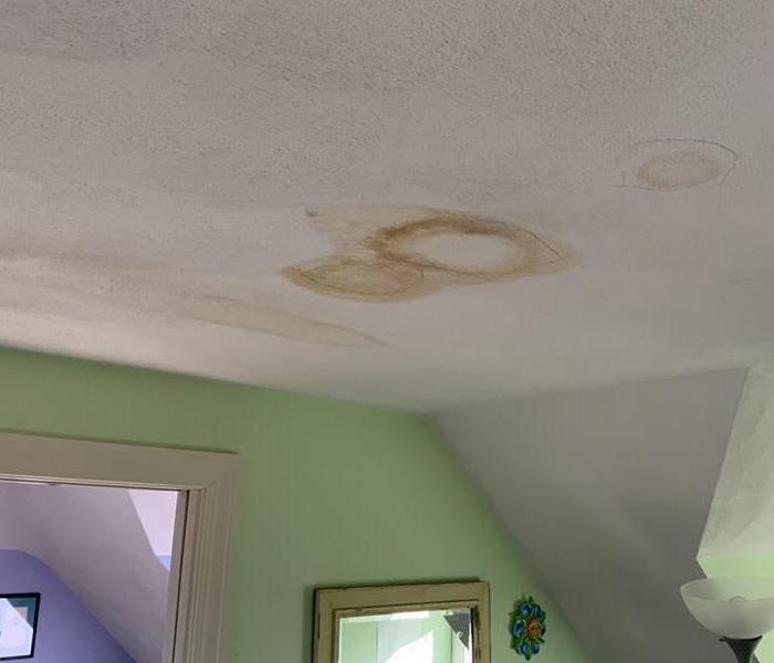 Water stains as a result of a slow roof leak.